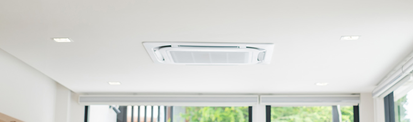 Moderne Deckenkassette einer Klimaanlage in einem hellen Büro sorgt für angenehme Raumtemperaturen und effiziente Kühlung.